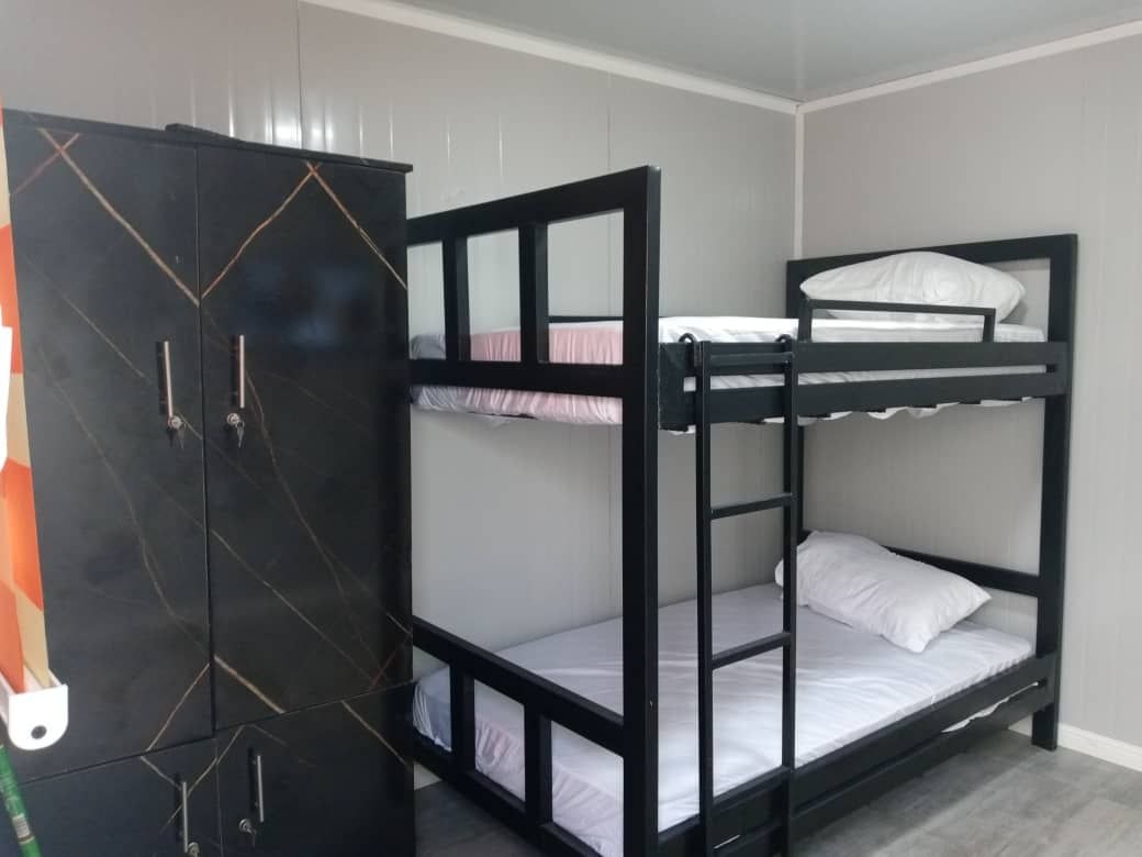 High-focus shot on wood-grain wardrobes and bunk beds - Space optimization